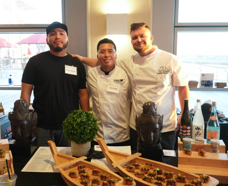 Atlas Restaurant Group and Stingray Sushi Bar & Asian Grill employees offer a spread of crispy rice and avocado rolls. Shown are (l-r) Stingray’s Derek Salazar and Juan Cotoc with Atlas’ Regional Corporate Chef Eli Jackson.