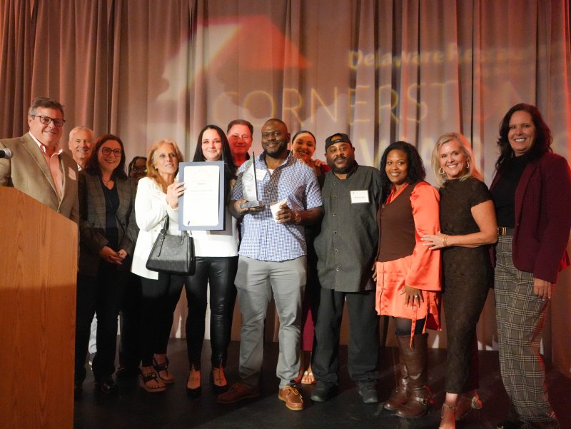 Palm Beach Bar and Grill receives the DRA’s first ever People’s Choice Award. Pictured are (l-r) DRA Chair Jeff Gosnear; Rep. Lyndon Yearick, R-Woodside; Rep. Claire Snyder-Hall, D-Rehoboth Beach; Paradise Bar and Grill’s Riana Willis, general manager Christine Mitchell, owner Kathryn Robinson, Michael Mitchell, owner and chef James Petion, manager Natalie Mitchell and chef Brian Lee; Rep. Alonna Berry, D-Milton; and DRA President and CEO Carrie Leishman.