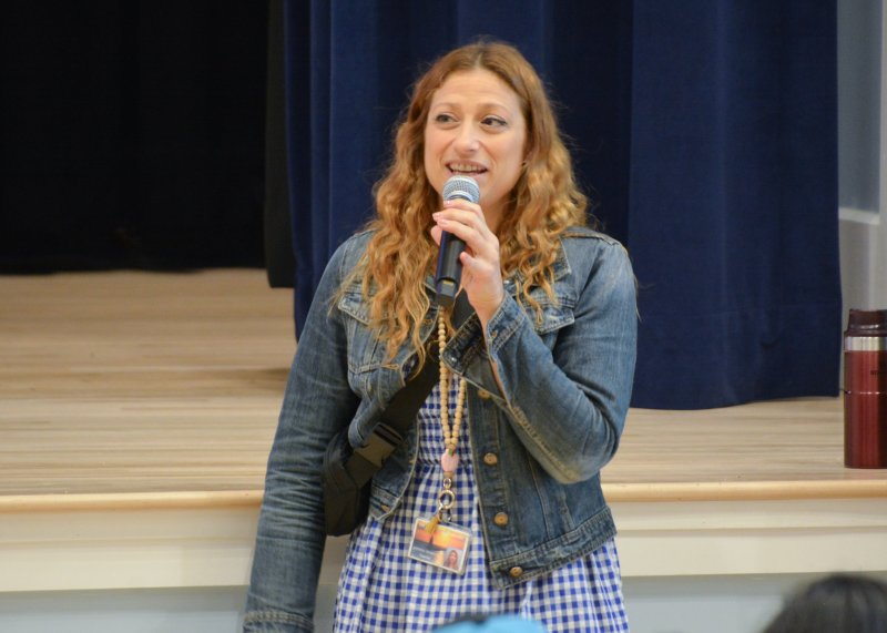 Veronica De Bartolo welcomes families and classmates to the auditorium.
