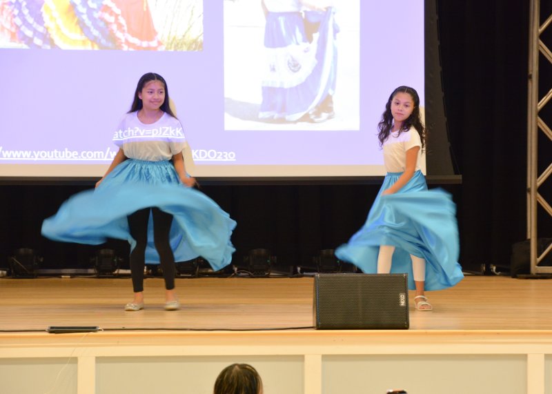 Maryorie Lux Ixcotoyac and Jaylen Calderon Martinez share a beautiful Salvadoran folk dance with guests, celebrating culture and tradition.