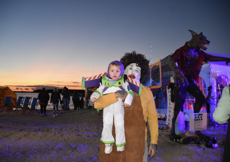 Buzz Lightyear soars into a night of fun as the sun sets over the bay.