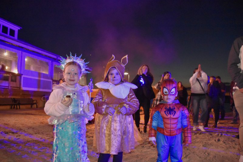 Ainsley, 4; Emilia, 5; and Oliver, 2, enjoy the haunted bonfire.