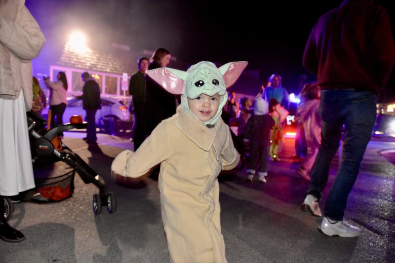 Oliver, 2, dressed as Yoda, dances to the music.