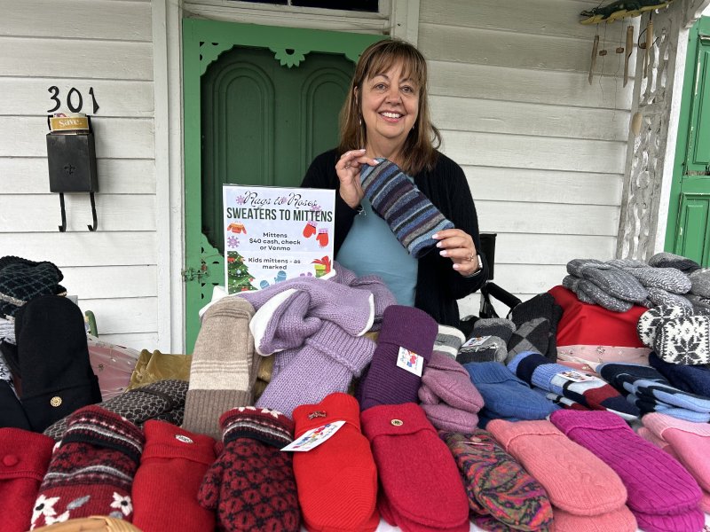 Georgia Dandeneau holds up a pair of her handmade mittens, created using recycled sweaters.