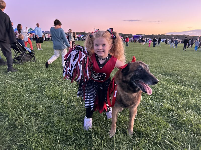 Isabella “Izzy” Embry and her dog Koda walk the grounds at Zombie Fest.