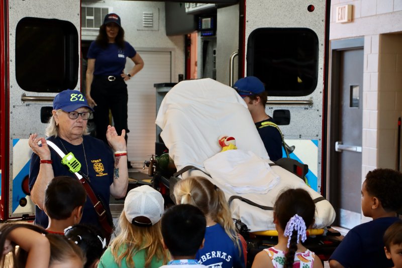 Firefighter Patty Marvel, left, shows off one of the Lewes Fire Department’s ambulances. She used a stuffed animal named Lance to show how a patient is strapped to a gurney.