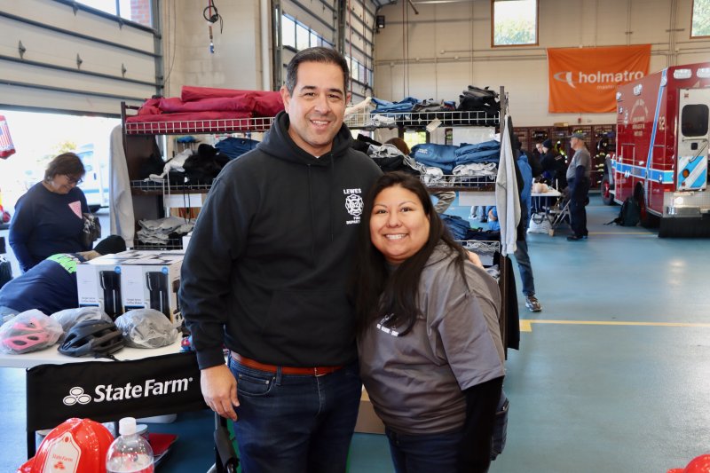 State Farm agent Tommy Taylor, left, and fire department volunteer Sarah Prieto give away some cool swag.