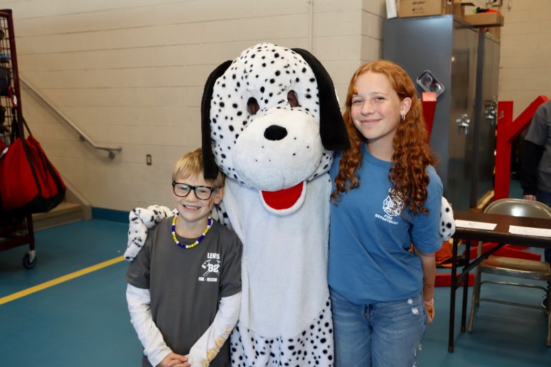 Sparky the fire dog with Wyatt Wilkinson, left, and Amelia Kennedy.