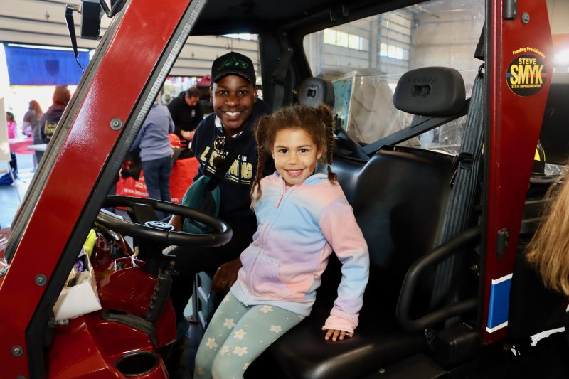 Lucy Russell, right, tries out the front seat of the Ranger ATV with dad, Preston Russell.