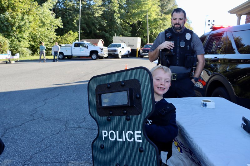 Nick Finkbeiner tries out a police shield, while Lewes officer Phillip Poorman looks on.