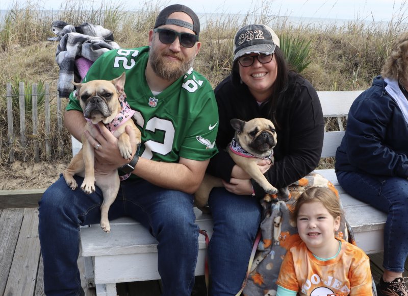 Alex, Jade and Molly McClure of Lewes pose with their dogs Minnie and Daisey as they watch the parade on the Boardwalk.
