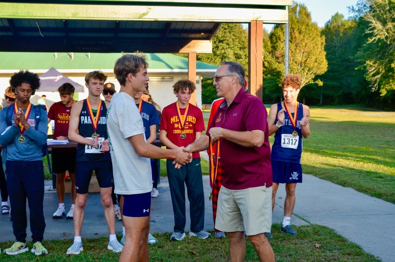 Seahawks senior Ryan Moody accepts his award after running the Winter Place Park course in 15:56 to win the Tidewater Classic.