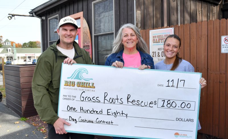Gathered for the check presentation are (l-r) Big Chill manager Blake Imhof, Grass Roots Rescue volunteer Sherri Cook and Emily Burns, Big Chill marketing coordinator. DAN COOK PHOTO
