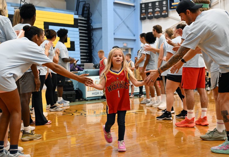 Wiz Kid Kaycee Stewart is welcomed to the court by the Cape Crusaders.