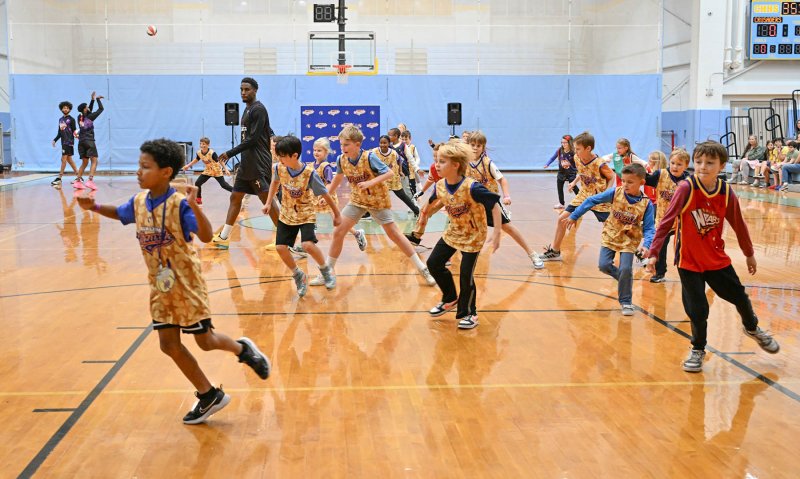 Harlem Wizards star Glitch, aka Bakari Copeland, gets the Wiz Kids warmed up before the show. DAN COOK PHOTOS