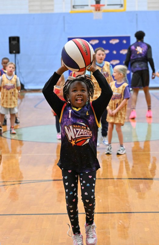 Mia Hall, 8, takes a jumper during the Wiz Kids warm up.
