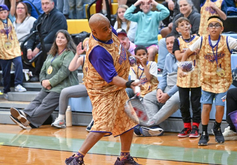 A-Train delivers free miniature Wizards basketballs to the crowd.
