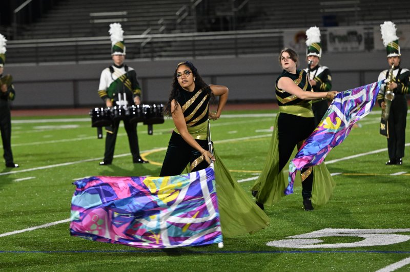 Yumalay Sanchez-Ozuna, left, and Madison Morgan perform with the Indian River flag corps.