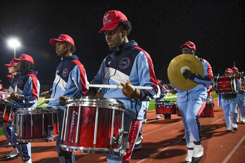 Jean Louis pounds out the cadence in the Delaware State drum corps.