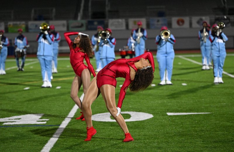Mikaela Gordon, left, and Camille Jeffries dance with the Delaware State dance squad.