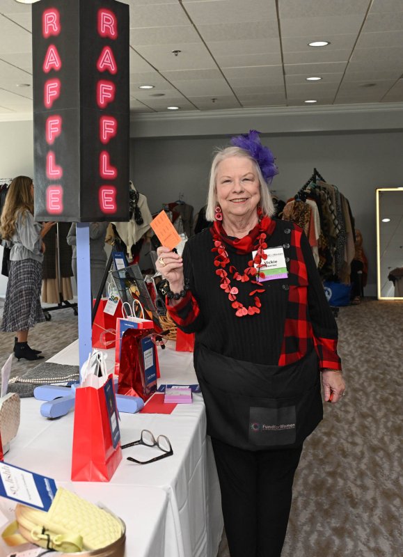 Volunteer Victoria Burrier sells raffle tickets at the event.