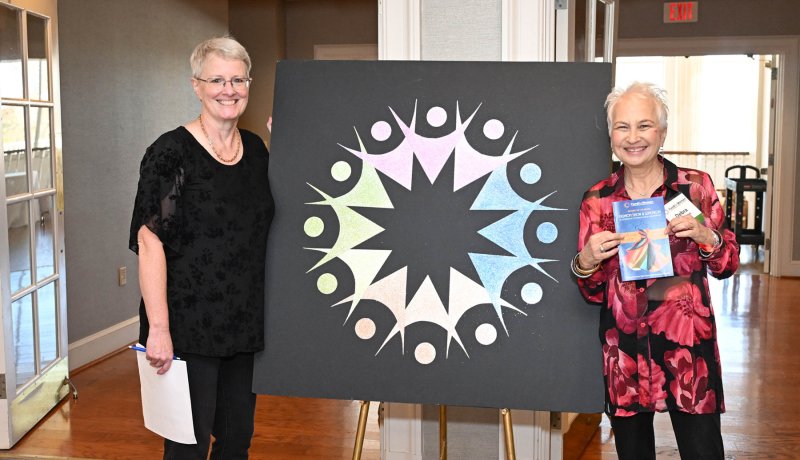 Founders Kelly Sheridan left, and Debra Quinton stand with the event logo.