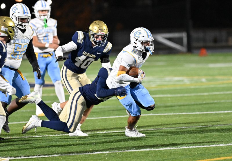 Ty Handy carries a Sals tackler for a gain.