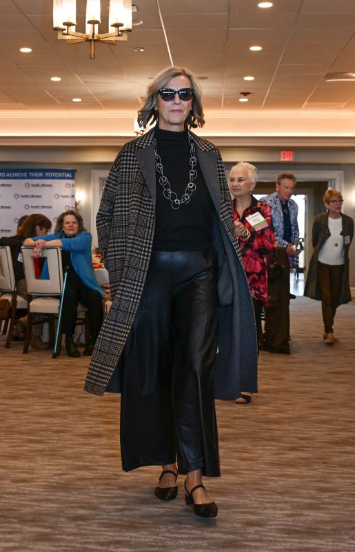 Bridget Buckaloo wears a faux leather pants and black sweater from Sty.Lishh.