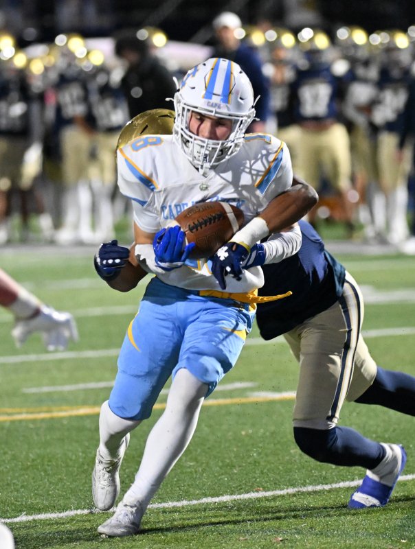 Junior wide receiver Aidan Lehmuth drags a tackler for a gain.