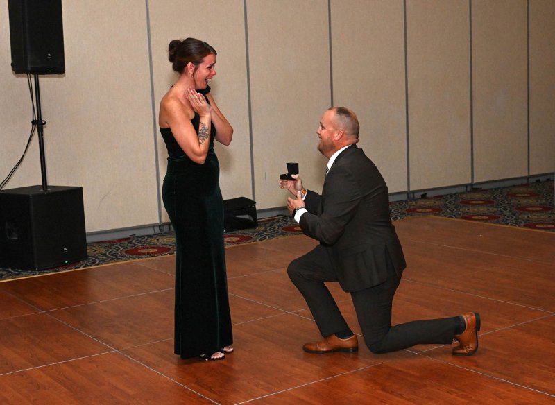A surprise proposal from Tyler Bryan to volunteer Laura Hudson highlights the dance floor at the event.