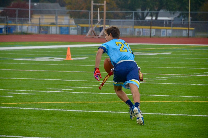 Cape senior Grant Conway scrambles to his right.