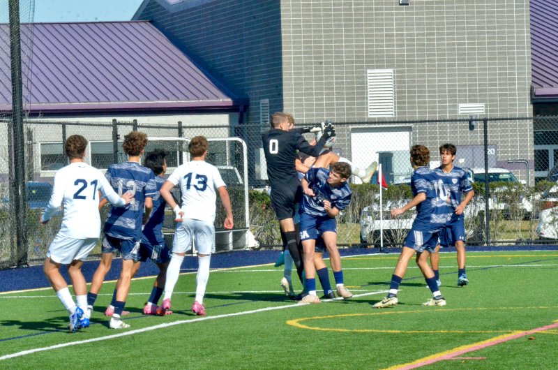 Sussex Academy senior Austin Taylor grabs the ball amidst a legion of limbs.