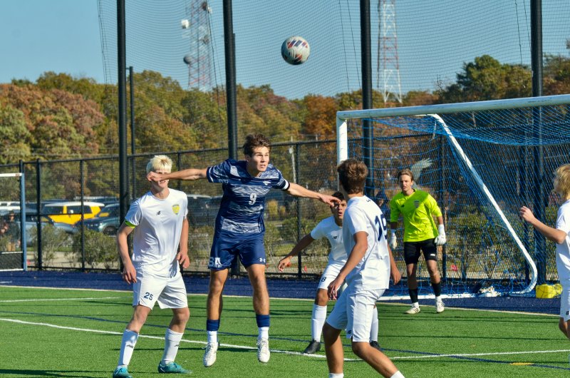 Seahawks senior George Sapna heads a throw-in back to the sideline.