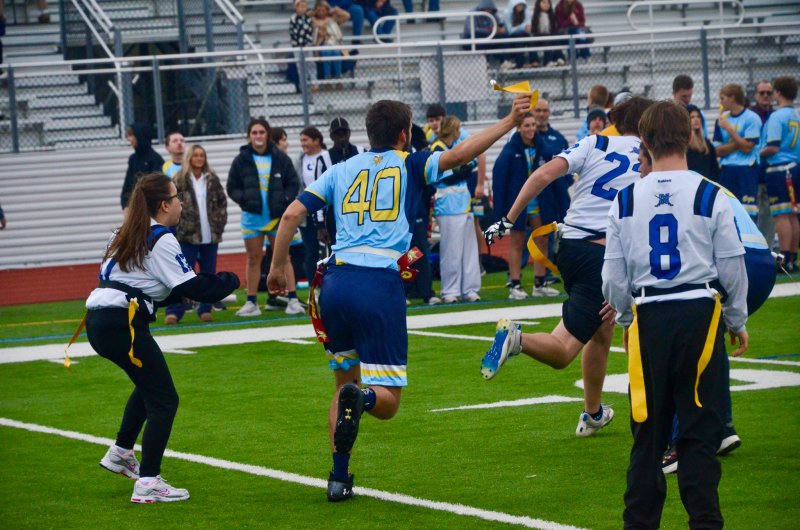 Vikings junior Jaxon Benton holds proof of his tackle for the ref to see.