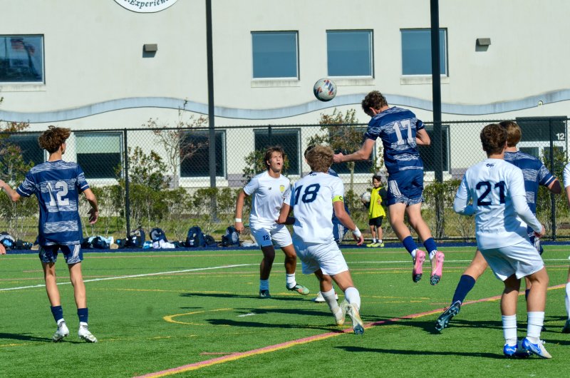 Sussex Academy senior Chase Ballinger heads the ball.