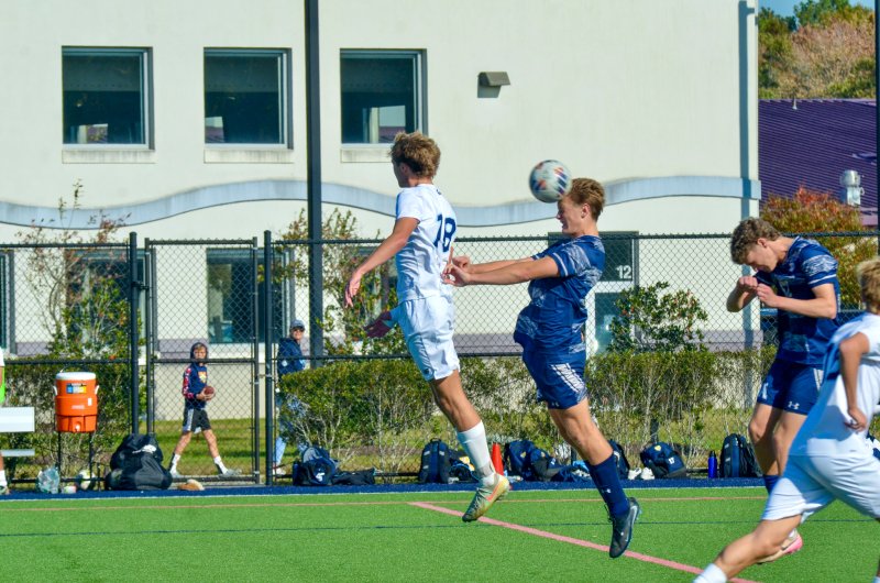 Sussex Academy junior Carson Klahr wins a header.