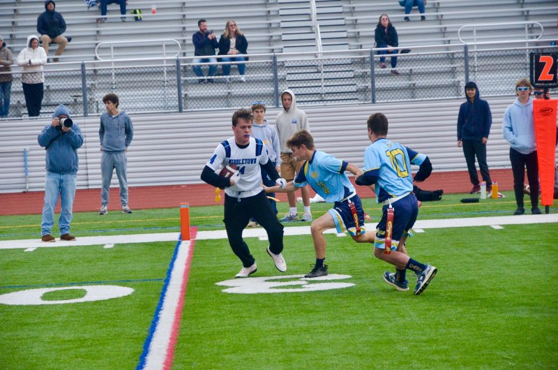 Cape senior Mason Trench pulls a flag with the help of Luke Archer at his side.