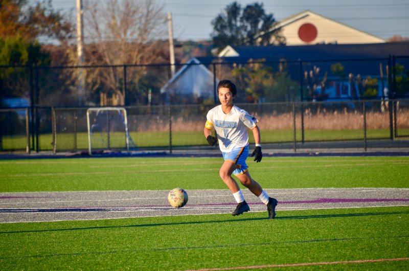 Mariner eighth-grader Andrew Burke controls the ball near the logo.