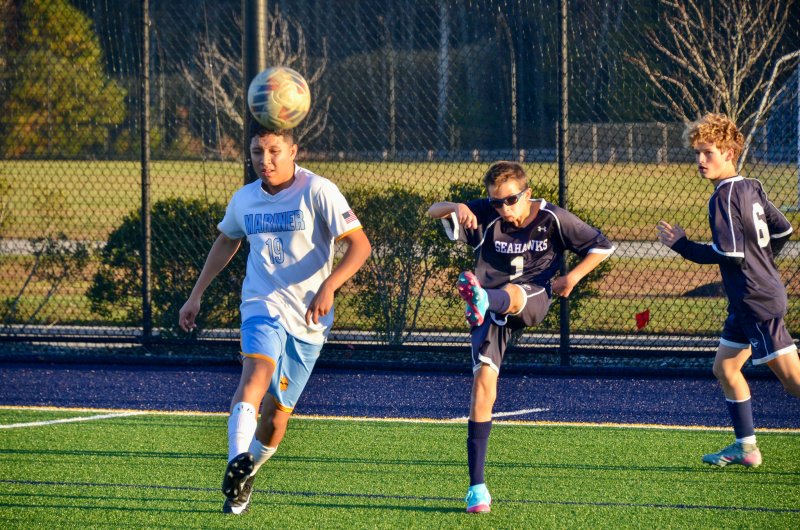 Seahawks seventh-grader Eli Evans clears the ball out of the corner.