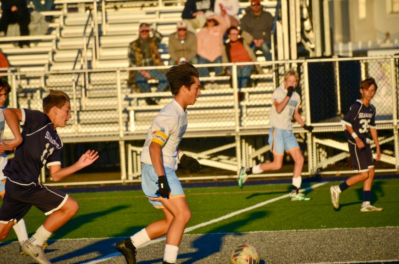Vikings eighth-grader Andrew Burke dribbles through the logo.