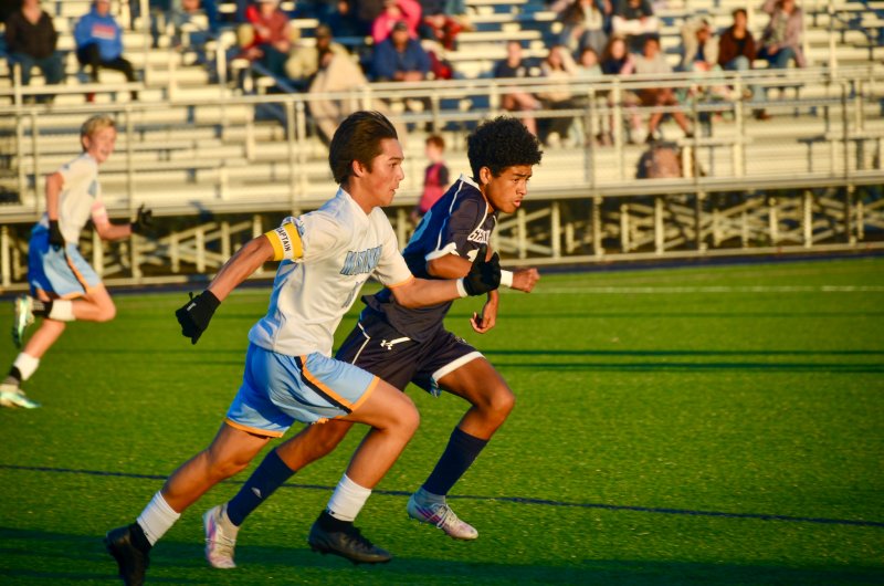 Mariner eighth-grader Andrew Burke races Carson Figueroa for the ball.