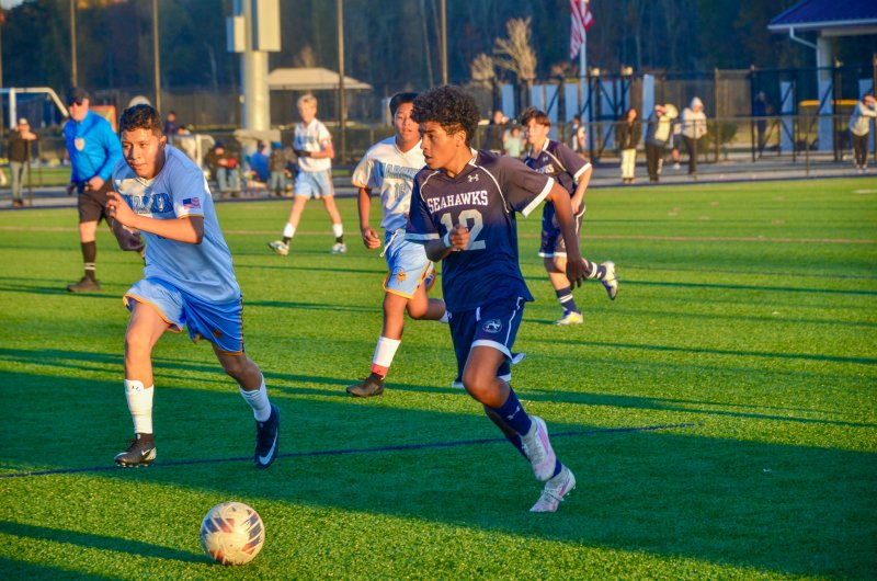 Sussex Academy eighth-grader Carson Figueroa carries deep into Vikings territory.