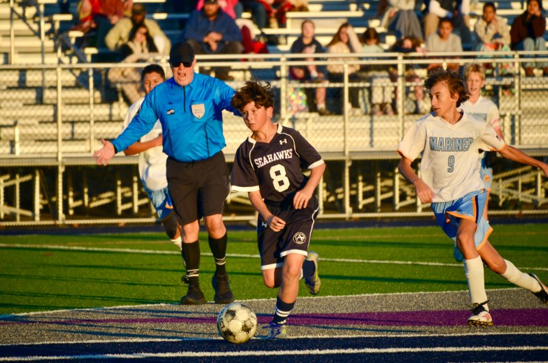 Seahawks seventh grader Tasman Bartles runs through the logo.