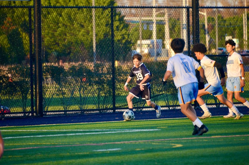 Sussex Academy eighth-grader Austin Brobyn works along the end line.