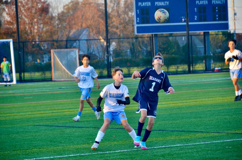Mariner seventh-grader Gabriel Blanshine jostles with Seahawks seventh-grader Eli Evans.