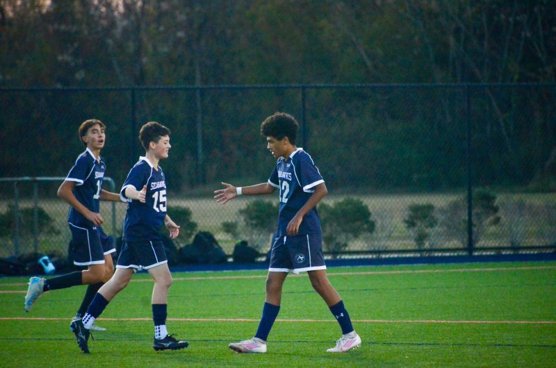 Sussex Academy eighth-grader Carson Figueroa, right, celebrates his goal with Austin DeSantis.