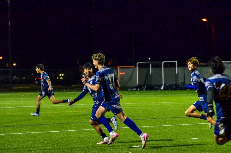No. 17 Chase Ballinger works his way to the student section with senior Ruendi Ortiz-Santos after the former opened the scoring early in the first half.