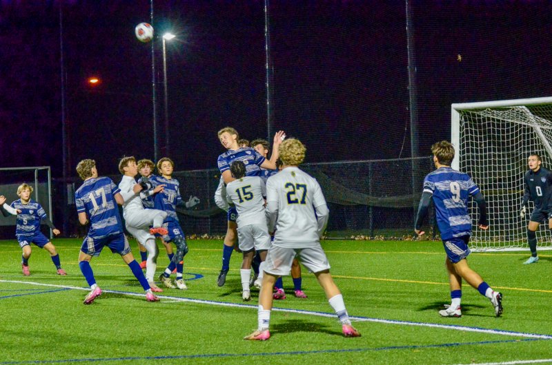 Seahawks junior Carson Klahr flies up on a corner to head the ball away.