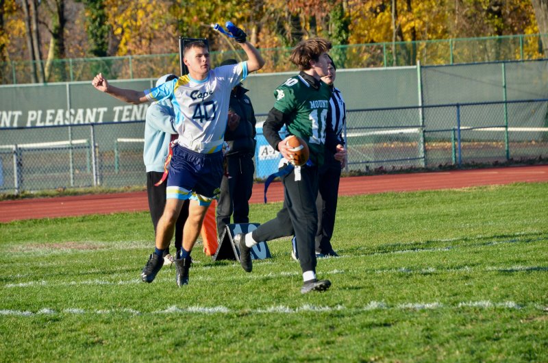 Cape junior Jaxon Benton holds up Graham Serpico’s flag.