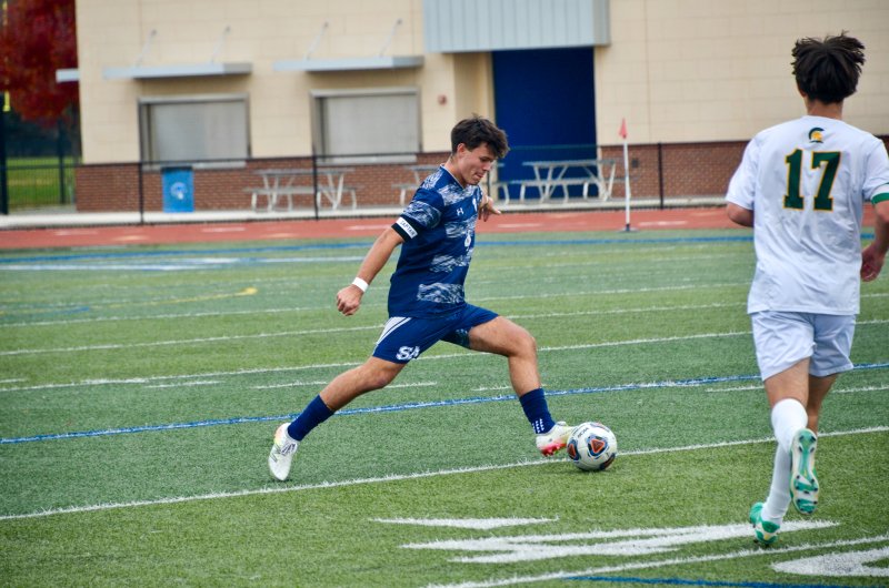 Sussex Academy senior Ben Steimel boots the ball out of his half.